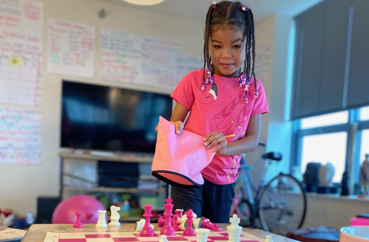 Little girl playing chess